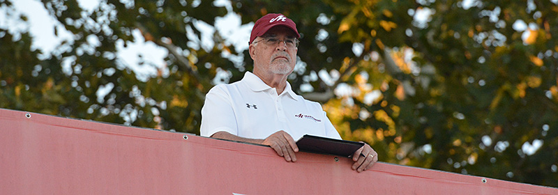 Mike Donnelly, watching his team's scrimmage from on top of the press box, without a headset.