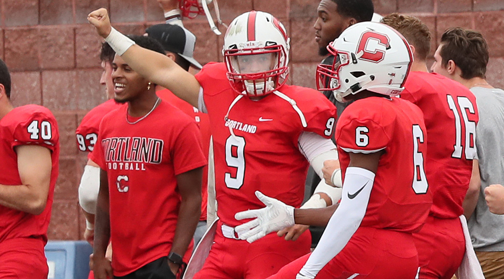 Brett Segala cheers on his team from the sidelines during a 95-yard kickoff return for a touchdown. (Cortland athletics photo by Darl Zehr Photography)