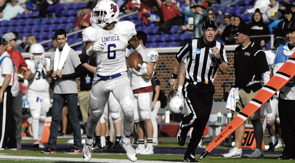 Boyd Marquardt runs up the sidelines alongside Linfield cornerback Kennedy Johnson in a 2016 playoff game at Mary Hardin-Baylor (provided photo).