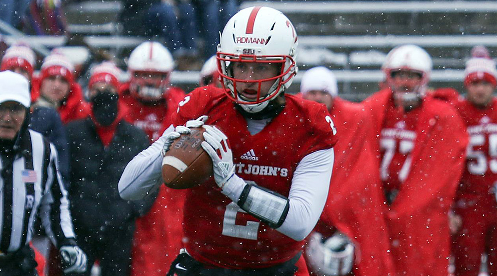 Jackson Erdmann rolling out for St. John's as snowflakes fall. (Photo by Jennifer McNelly for St. John's athletics)