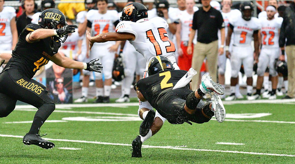 Manny Longoria dives to stop a Hendrix ball-carrier in a 2018 Texas Lutheran athletics file photo.