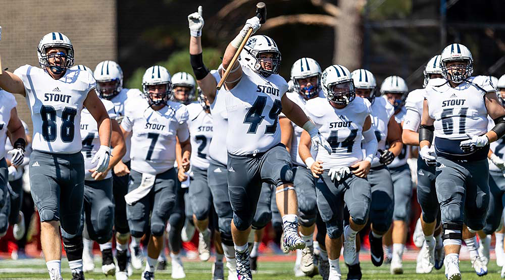 Aaron Wisecup and the UW-Stout defense run onto the field. (UW-Stout athletics file photo)