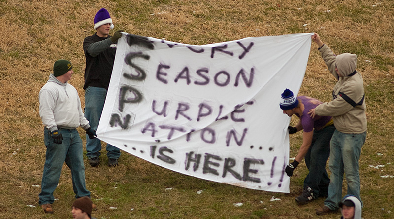 Fans holding a banner that says Every Season Purple Nation is here.