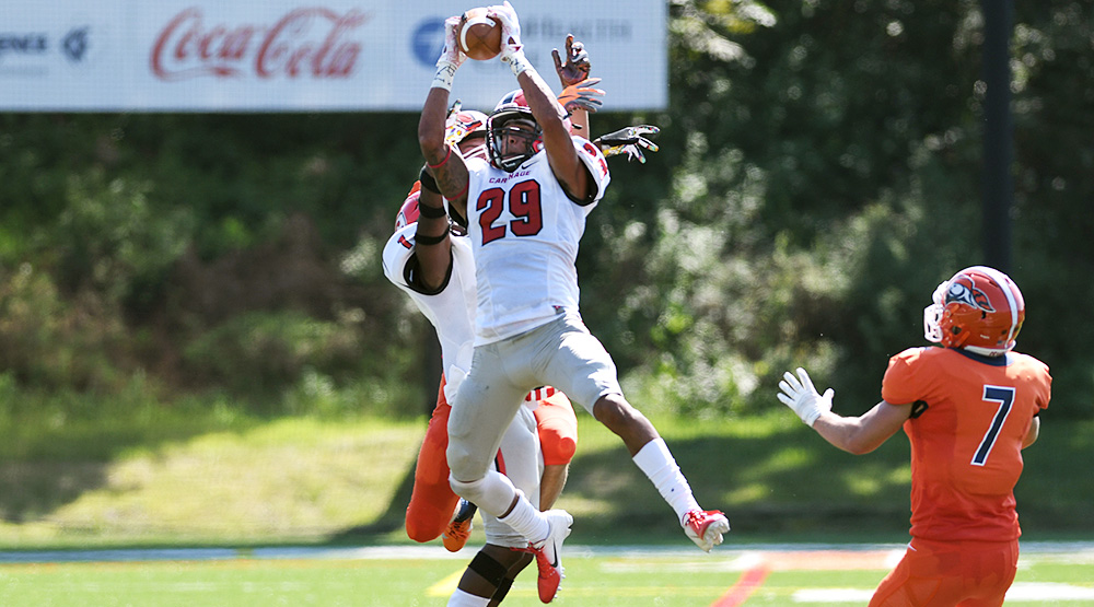 Amani Dennis skies in front of a Carroll receiver to intercept a pass. (Carthage athletics photo)