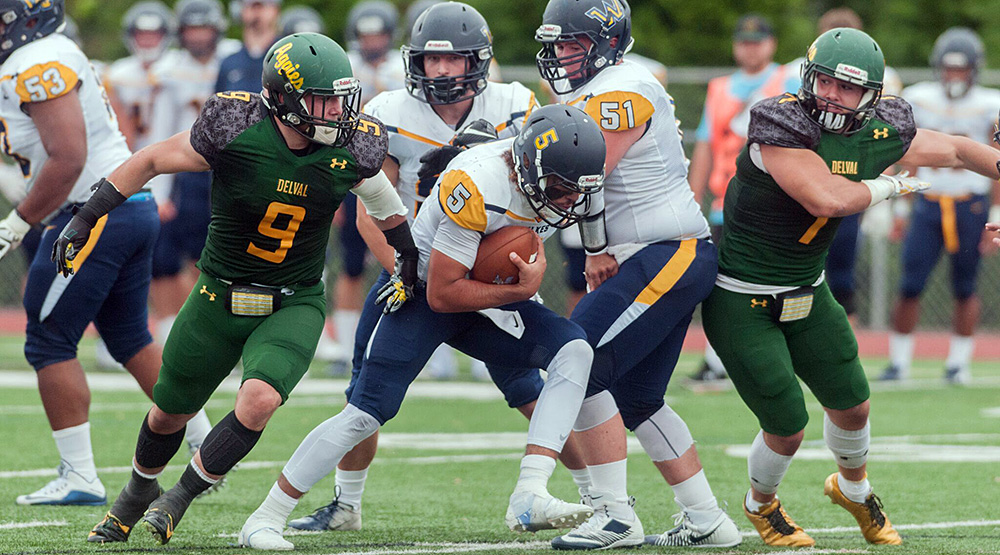 Anthony Nobile, left, and Michael Nobile, converge on the Wilkes quarterback. (Delaware Valley athletics photo)