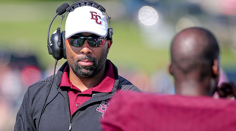Nick Johnson, on the sidelines midseason in a cap, sunglasses and headset. (Earlham athletics photo)