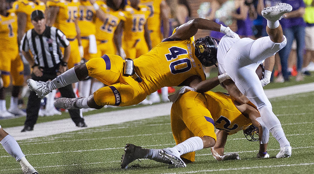 De Jackson flies parallel to the ground to help bring down a Hardin-Simmons ballcarriers. (UMHB athletics photo)