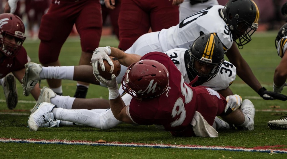 Mark Riggio reaches the ball out in a goal line situation for Muhlenberg. (Photo by Tom Nettleton, d3photography.com)