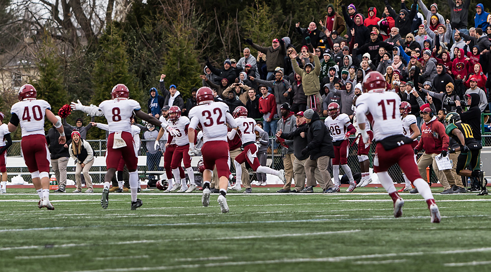 Nick Sirico (27) runs down the far sideline as the sideline erupts. (Photo by Tom Nettleon, d3photography.com)