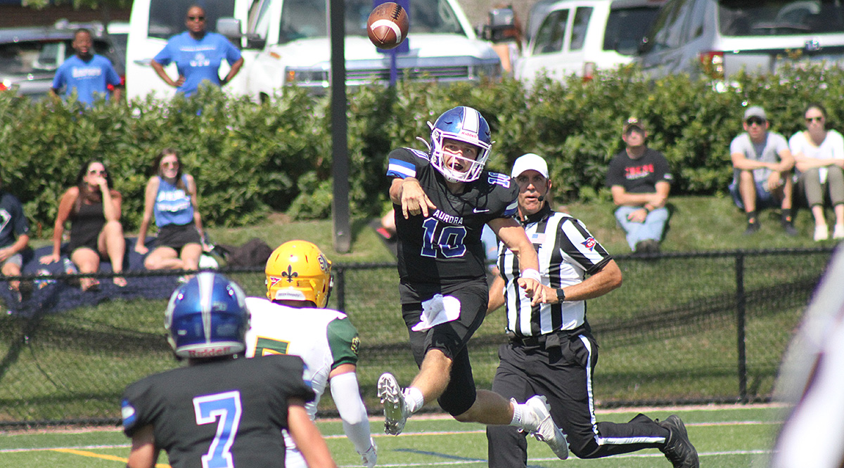 Gavin Zimbelman, airborne, throwing a pass for Aurora vs. St. Norbert.