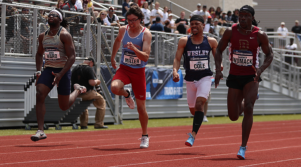 Devonta Womack, right, takes the lead in the 100-meter finals